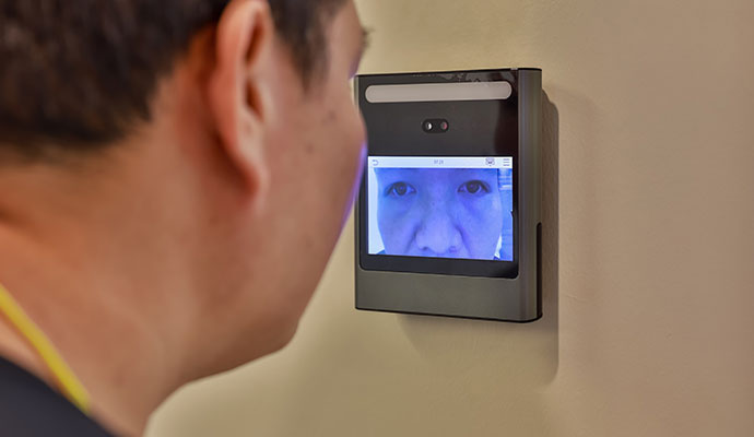 Person using retinal scanner access system