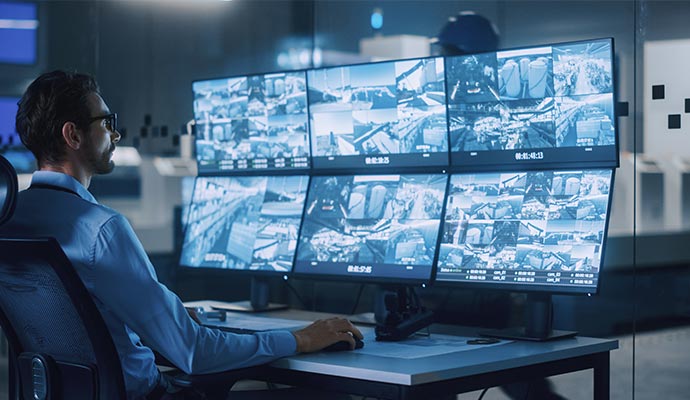 A person monitoring live video feeds