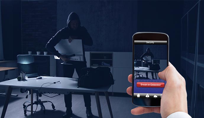 Mobile device showing a break-in alert with live video of an office intruder