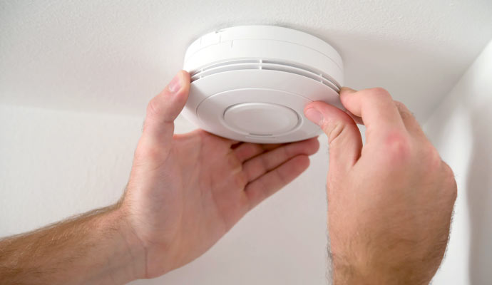 A person installing fire alarm system