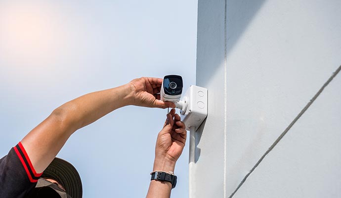 Technician installing outdoor CCTV camera
