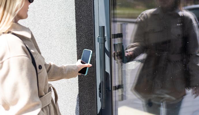 Woman using a smartphone-based access control system